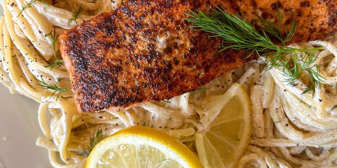 Pasta in Creamy Lemon Dill topped with Norwegian Salmon by Heifa Odeh