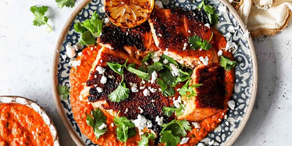 Salmon from Norway over salsa topped with cilantro feta cheese and grilled lemon