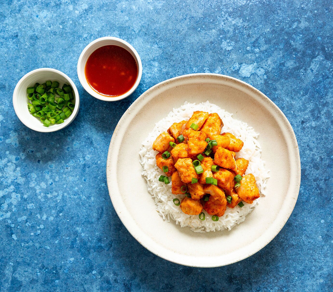 Fried salmon bites coated in an apple bourbon sauce atop rice. 