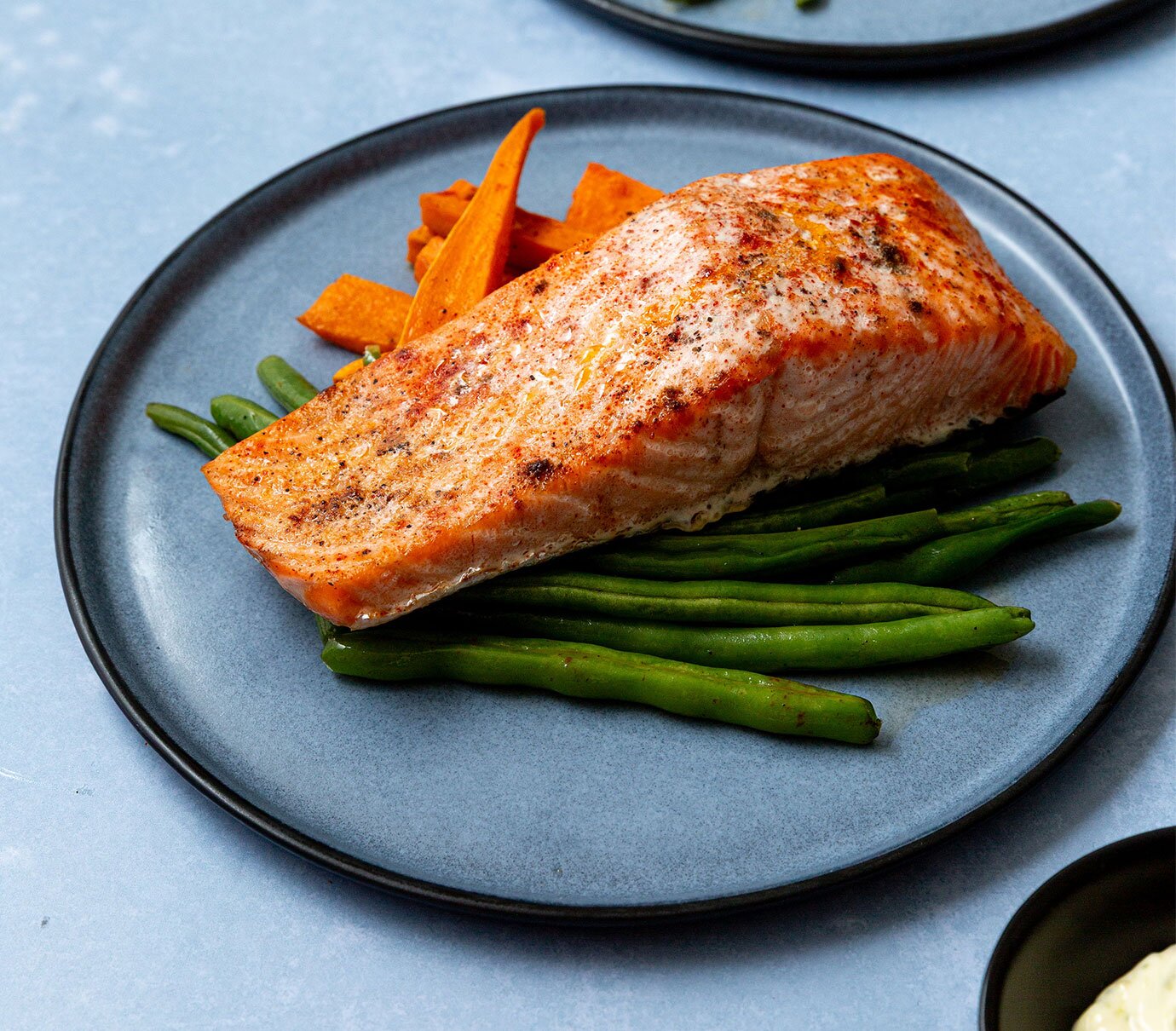 Salmon filets with baked sweet potato fries and green beans. 