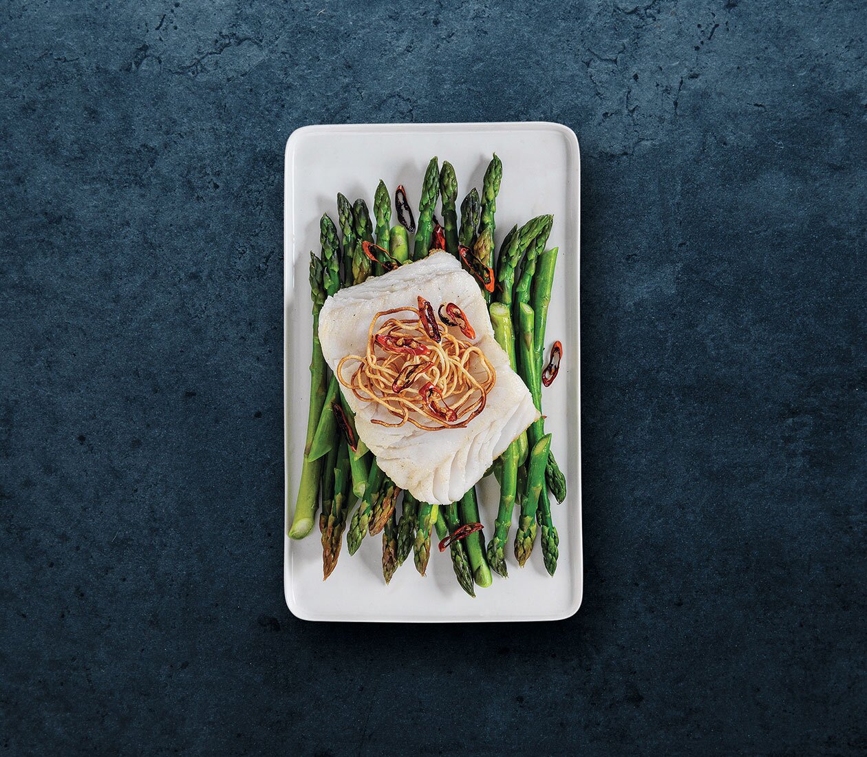 Norwegian cod on a bed of asparagus