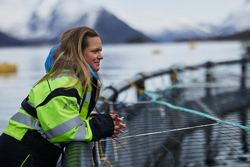 Woman looking out over sea pen